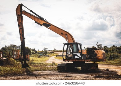 Abandoned old excavator in quarry. Heavy equipment - The old yellow excavator thrown into a field. - Powered by Shutterstock