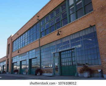 Abandoned Old Factory, Exterior Facade View, Green Framed Doors and Large Industrial Windows, Multi-story building