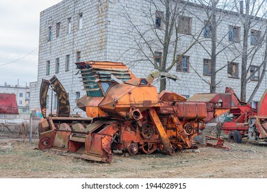 Abandoned Old Farm Equipment, Tractors, Trailers And Combines. The Equipment Is Rusty And Broken. 