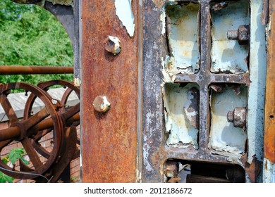 Abandoned Old Industrial Machinery With Rusting Orange Metalwork.