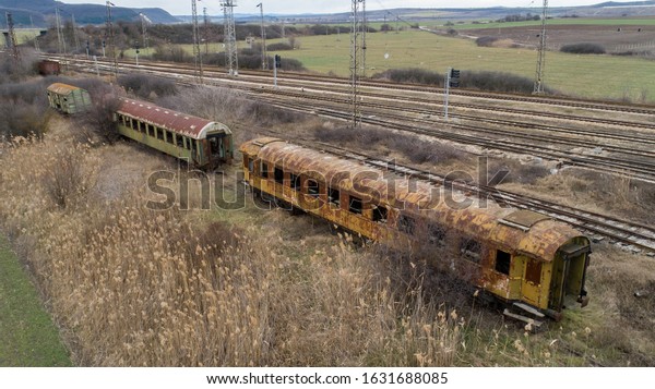Abandoned\
old railway wagons at station. Old train\
wagons