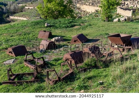 Abandoned old rusty minecarts in the Roman ruins of the ancient city of Cuicul-Djemila, Setif, Algeria.