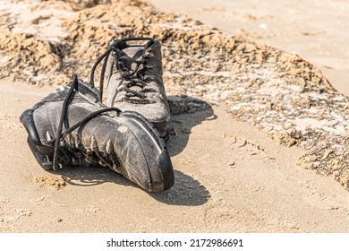 abandoned old shoes on the sand