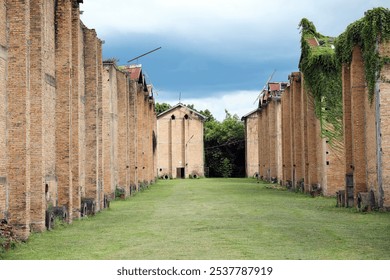 An abandoned old tobacco curing barn, weathered by time and no longer in use. The rustic wooden structure stands as a relic of the past, showcasing the history of traditional tobacco farming. - Powered by Shutterstock