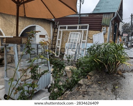 Abandoned outdoor market with disarrayed objects.