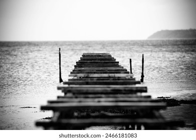 Abandoned Pier Extending into the Sea, Black and White - Powered by Shutterstock