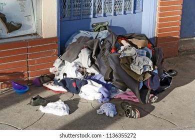 Abandoned Pile Of Clothes Outside Store Front.