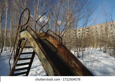 Abandoned Playground In Ghost Town Pripyat, Post Apocalyptic City, Winter Season In Chernobyl Exclusion Zone, Ukraine