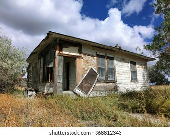 Abandoned prairie shack with broken windows and door - landscape photo