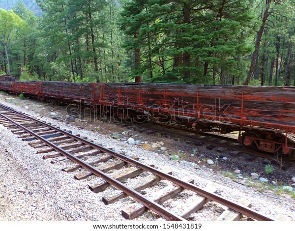 Abandoned rail cars line a\
rail road track deep in the San Juan Mountains near Silverton,\
Colorado. 