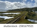 Abandoned railway track on a coatal wetland landscape, dramatic clouds sky, South Africa, Knysna town