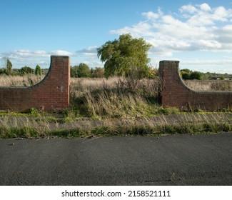 Abandoned Road And Remains Of Ornamental Gateway On Brownfield Land, Formally A Built Up Urban Area 