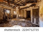 An abandoned room in the ruins of an old house. Ruined house room. Dirty room in ruined building. Dirty disorder in abandoned room