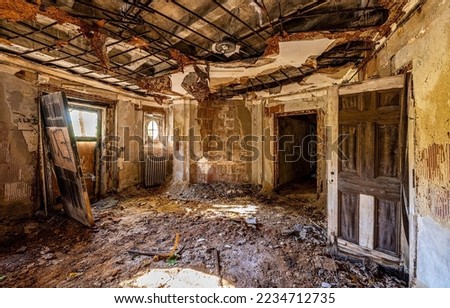 An abandoned room in the ruins of an old house. Ruined house room. Dirty room in ruined building. Dirty disorder in abandoned room