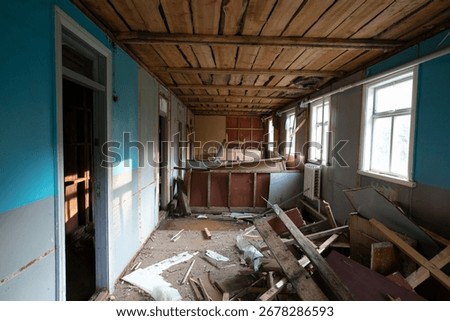 Abandoned room showcasing decay and disarray in a derelict building during daylight hours