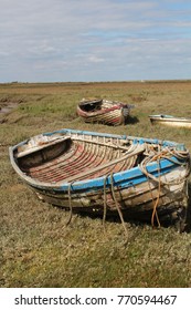 Abandoned Rotten And Derelict Rowing Boat On Dry Land. Norfolk UK