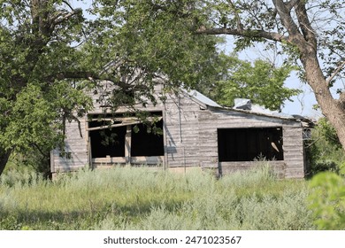abandoned rural farmhouse with attached shed - Powered by Shutterstock