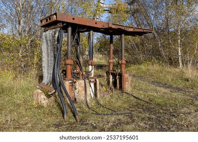 Abandoned rusty 1970s coal mine machinery: coalface roof supports called chocks with hydraulic rams and pipes - Powered by Shutterstock