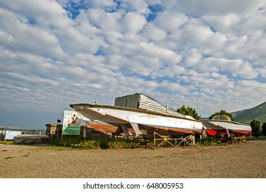 Abandoned Rusty Boats On A Dramatic Cloudy Sky Background. Sevan, Armenia