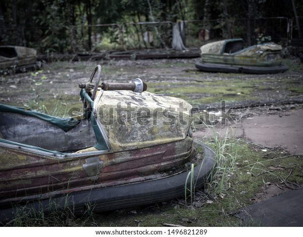 Abandoned rusty bumper cars (aka dodgems, bumping\
cars, dodging cars, dashing cars) in the Pripyat amusement park,\
Chernobyl Exclusion Zone,\
Ukraine