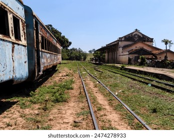 Abandoned, rusty and deteriorated second-class passenger carriage next to the Val de Palmas railway station, also abandoned, in the municipality of Bauru, state of Sao Paulo - Powered by Shutterstock