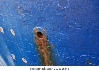 Abandoned And Rusty Limber Hole On The Side Of Docked Ship Outside. Closeup Of Rust Stained Hawsehole Used For Draining Water On The Hull Of A Nautical Boat In A Dockyard And Port Overseas And Abroad