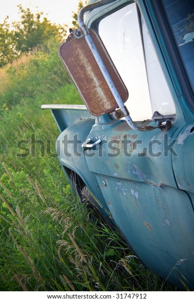 Abandoned rusty old truck in a\
field