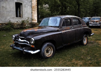 An abandoned rusty vintage car parked in the yard of a house in a village. - Powered by Shutterstock