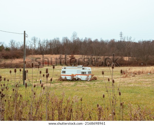 Abandoned\
RV, Trailer in an empty field in the\
Midwest