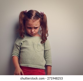 Abandoned Sad Kid Looking Down With Pain On Face. Closeup Vintage Portrait With Empty Copy Space