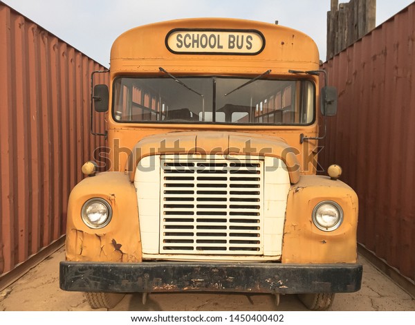 abandoned school bus\
parking near\
container