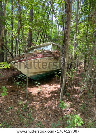 Abandoned speed boat in the woods