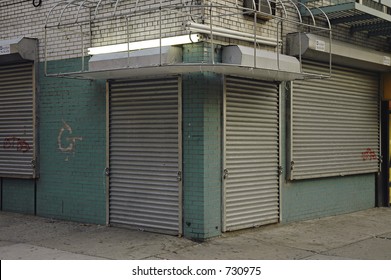 Abandoned Storefront With Gate Down