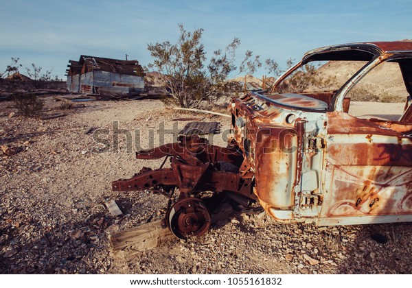 Abandoned town in the desert with rusty cars and
destroyed houses.