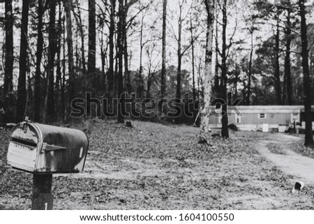 Abandoned trailer and tilted mailbox, rustic look, in suburban Mississippi
