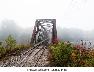 Abandoned Train Bridge Surrounded By Fog, Over The Pemi River In New Hampshire. Fall Leaves Changing Bg