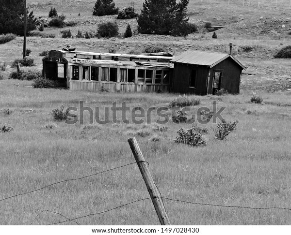 An abandoned train\
car once used as make shift home now sits among the mining ruins\
near Victor, Colorado. 
