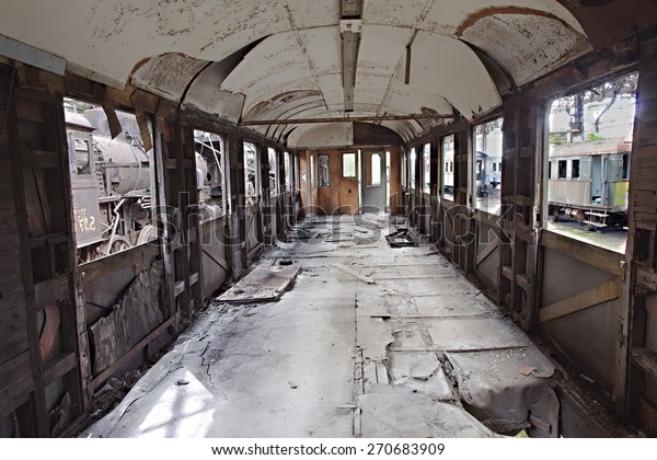 Abandoned\
train carriage with interior falling\
apart