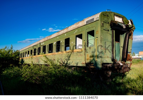 Abandoned train. Forgotten overgrown railway.\
Old rusty railway\
carriage
