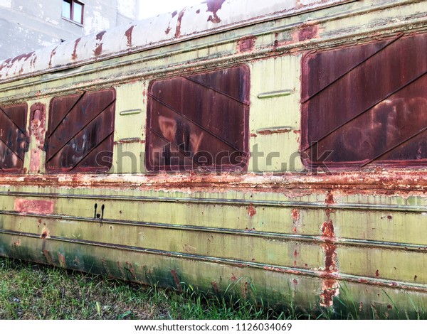 Abandoned train. Forgotten overgrown railway.\
Old rusty railway\
carriage.