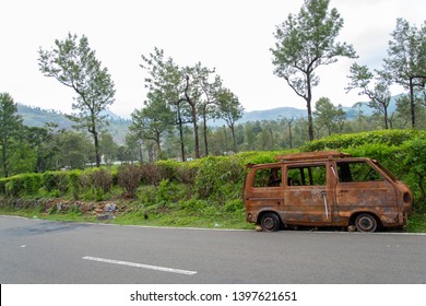 Abandoned van parked in side of hill road in a foggy bright day