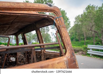 Abandoned van parked in side of hill road in a foggy bright day