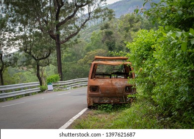 Abandoned van parked in side of hill road in a foggy bright day