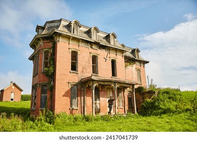 Abandoned Victorian Mansion with Overgrown Garden and Relaxed Explorer - Powered by Shutterstock
