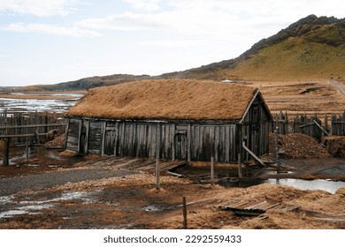 Abandoned viking village in Stokksnes, Iceland. The replica of the Viking houses and boats on the shore gives us a glimpse of how the Vikings used to live in the past.