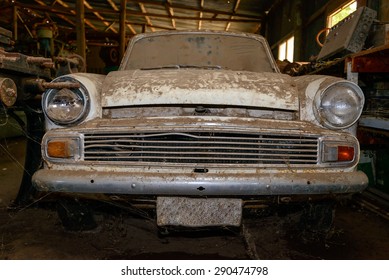 Abandoned vintage car covered with layer of dust in the shed - Powered by Shutterstock