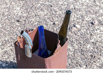 Abandoned Wine Bottles And An Oil Spout In A Rusty Metal Box