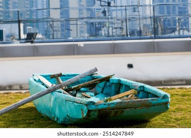 An abandoned wooden boat lying on the grass - Powered by Shutterstock