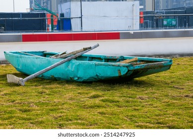 An abandoned wooden boat lying on the grass - Powered by Shutterstock