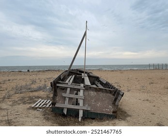 Abandoned wooden boat on the seashore - Powered by Shutterstock